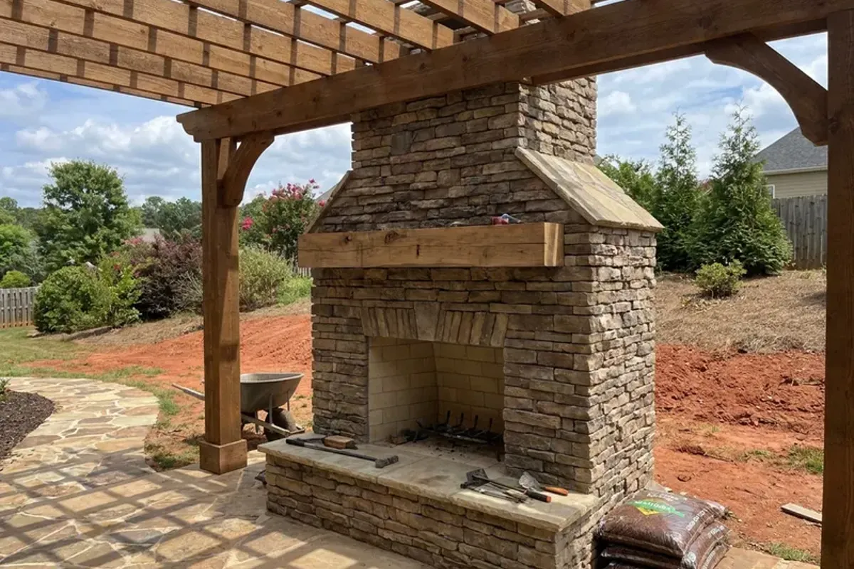 Stone outdoor fireplace on a covered patio