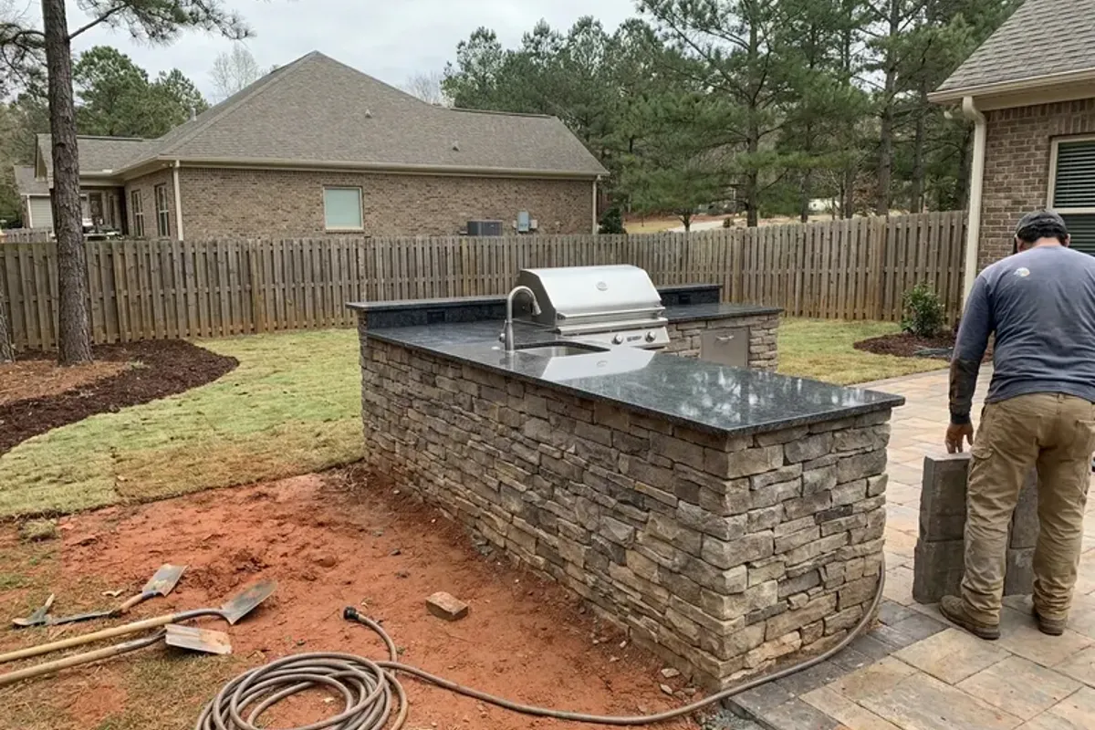 Outdoor kitchen with grill and granite counter