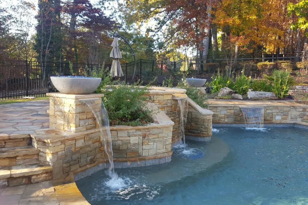 Pool with natural stone waterfall by 4 Seasons
