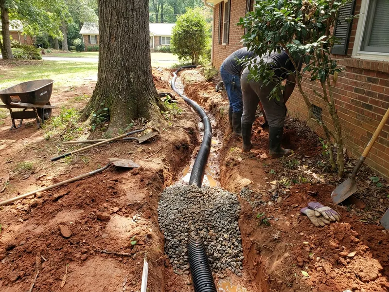 French drain trench with gravel and perforated pipe