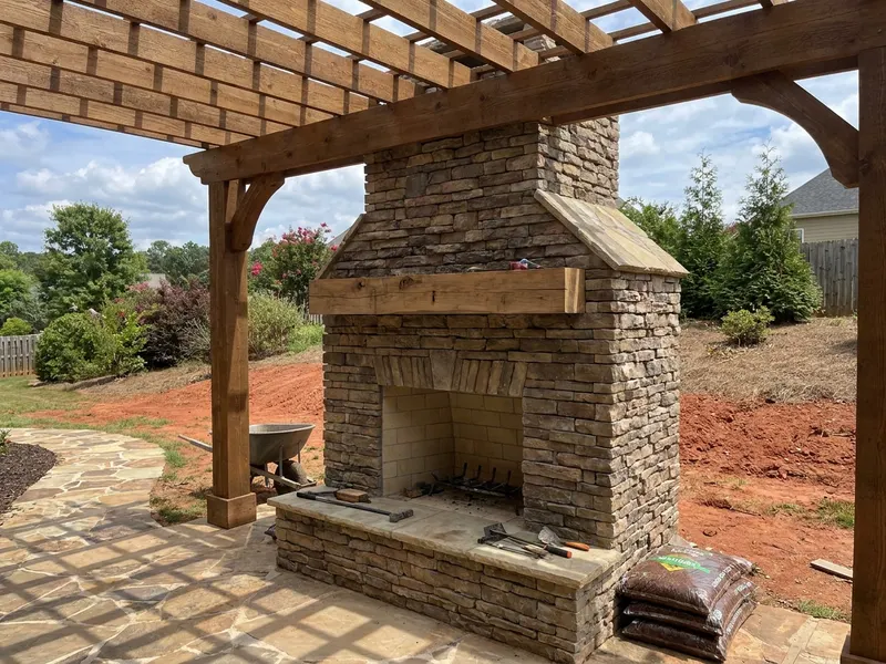 Stone outdoor fireplace on a covered patio