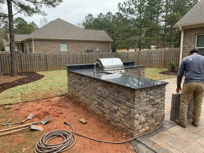 Finished outdoor kitchen with grill and granite counter