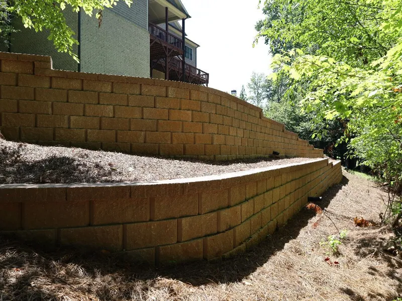 Segmental block retaining wall terracing a slope, built by 4 Seasons